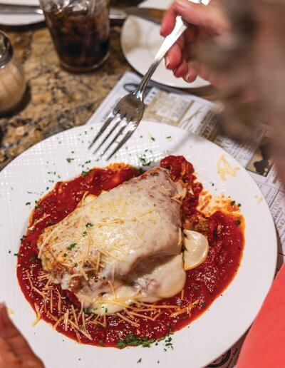 Person about to eat a chicken parmesan.